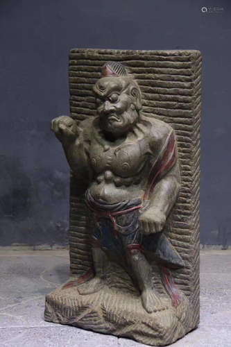 A STONE CARVED FIGURE