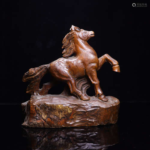 A WOOD HORSE SCULPTURE