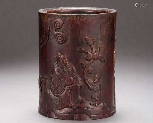 A Chinese carved storied wood brush pot from Qing