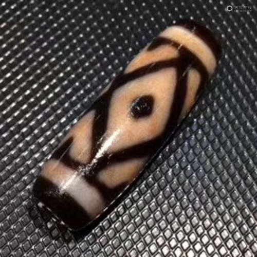 A CINNABAR FIVE-EYE JIN GANG DZI BEAD