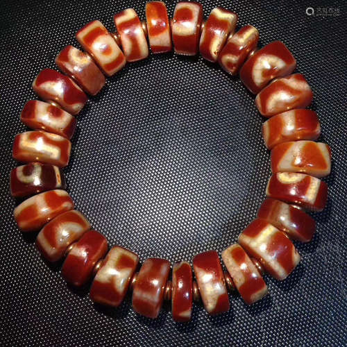 A HIGHLY OILY BROKEN BEAD BRACELET