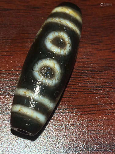 AN OLD ORE CHARGE FIVE-EYE DZI BEAD