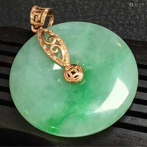 A NATURAL RING-SHAPED JADEITE PENDANT