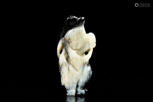 BLACK AND WHITE JADE CLEVERLY CARVED 'BOY' ORNAMENT