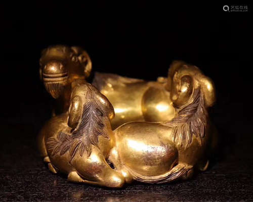 A GILT BRONZE BEAST PENDANT