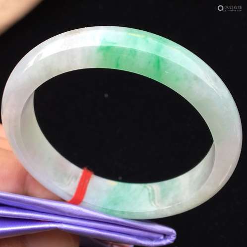 A NATURAL JADEITE BANGLE