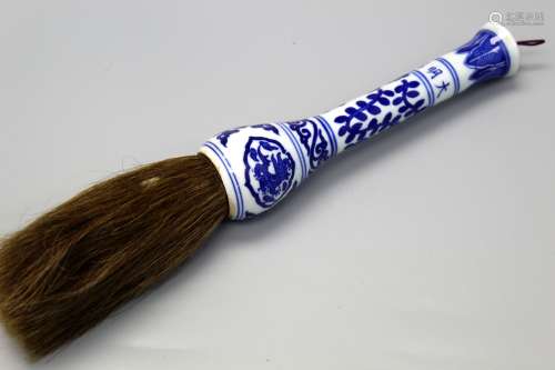 Chinese brush with blue and white porcelain handle.