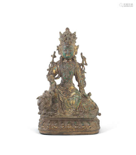 Late Ming Dynasty A gilt-bronze figure of Guanyin on a Buddhist lion