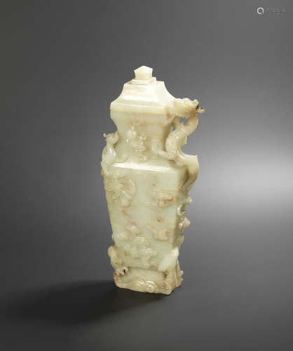 Qianlong A rare pale green jade 'dragons' vase and cover