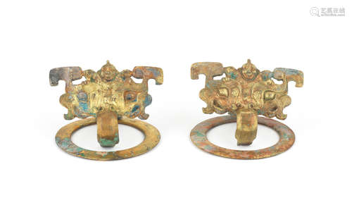 Warring States Period/Han Dynasty A rare pair of gilt-bronze 'taotie and figure' door handles, pushou