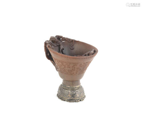 17th/18th century A rhinoceros horn archaistic 'nine-dragon' libation cup