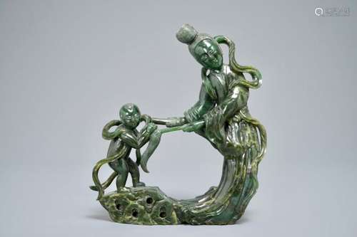 A CHINESE SPINACH GREEN JADE GROUP OF GUANYIN WITH A CHILD, 19TH C.