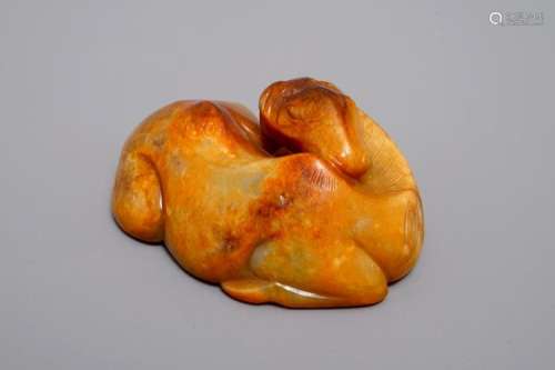 A CHINESE CARVED RUSSET JADE MODEL OF A RECLINING HORSE, 19/20TH C.
