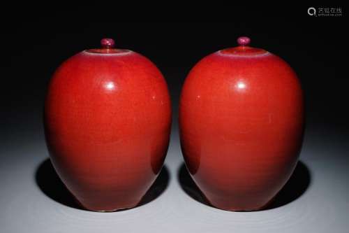 A PAIR OF CHINESE EGG-SHAPED MONOCHROME OXBLOOD-GLAZED JARS AND COVERS, 19TH C.
