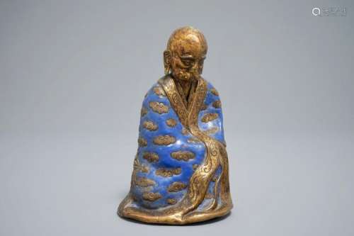 A CHINESE CHAMPLEVÉ ENAMEL AND GILT COPPER MODEL OF A LUOHAN, QIANLONG