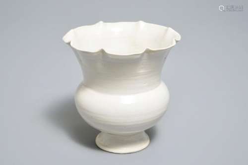 A CHINESE FOLIATE-RIMMED CREAM-GLAZED DINGYAO BOWL ON FOOT, SONG OR LATER