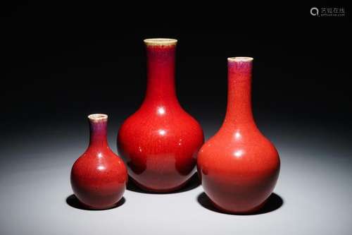 THREE CHINESE MONOCHROME OXBLOOD-GLAZED BOTTLE VASES, 19/20TH C.