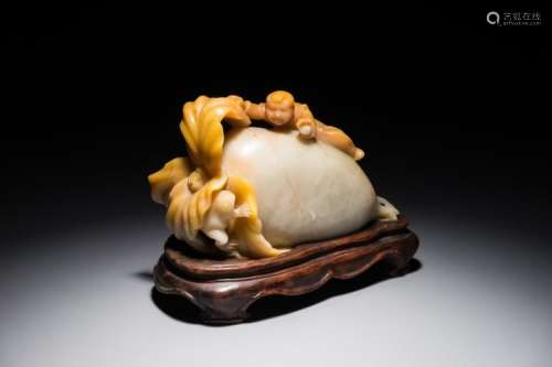 A CHINESE JADE GROUP OF A RAPHANUS WITH A PLAYING BOY AND FROG, 19/20TH C.