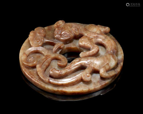 A large mottled green and russet jade 'chilong' archaistic disc, bi