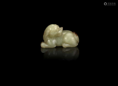 A yellow and russet jade carving of a lion