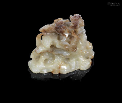 Ming Dynasty A pale green and brown jade reticulated attachment