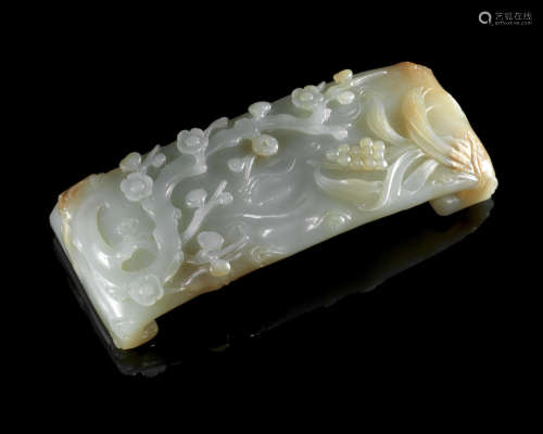 Qing Dynasty A pale green and russet jade 'prunus' wrist rest