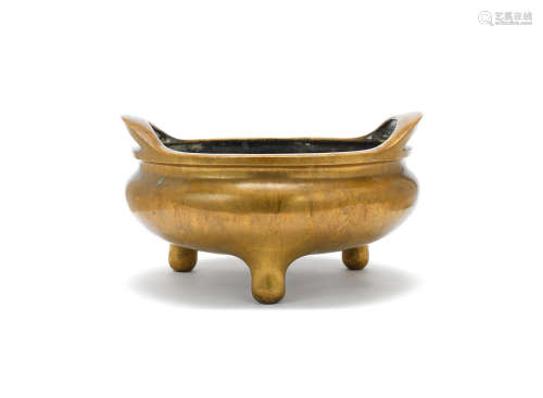 Xuande six-character mark, 17th/18th century A large gilt-bronze tripod incense burner