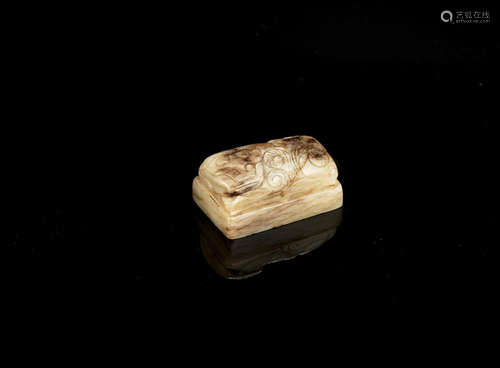 Ming Dynasty A mottled cream and brown jade animal weight