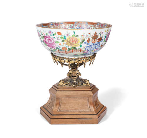 The porcelain: China, Qianlong, the stand: Europe, mid-19th century A massive famille rose punch bowl and gilt-bronze and rosewood stand