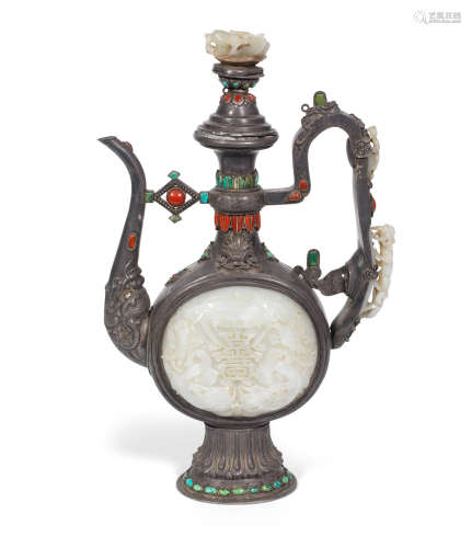 The jades: China, 17th to 18th/19th century, the ewer: Tibet, 19th century A coral, turquoise and jade-inset silver ewer