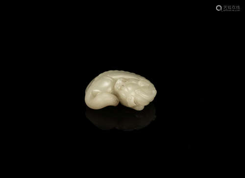 A pale green jade carving of a horned mythical beast