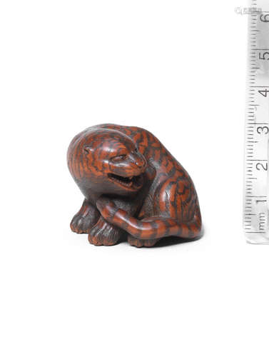 By Masanao, Yamada, Ise Province, Edo period (1615-1868), 19th century A wood netsuke of a tiger