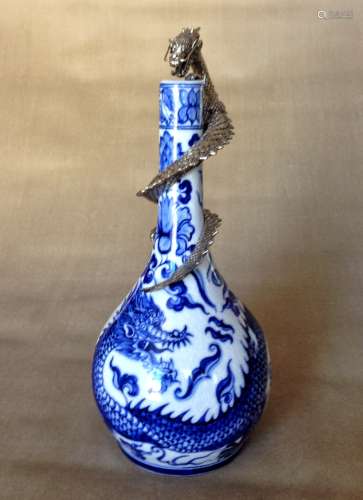 A BLUE AND WHITE DRAGON WITH METAL DRAGON FLASK