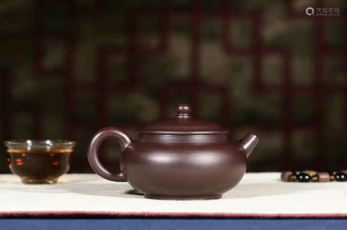 A PURPLE CLAY TEAPOT