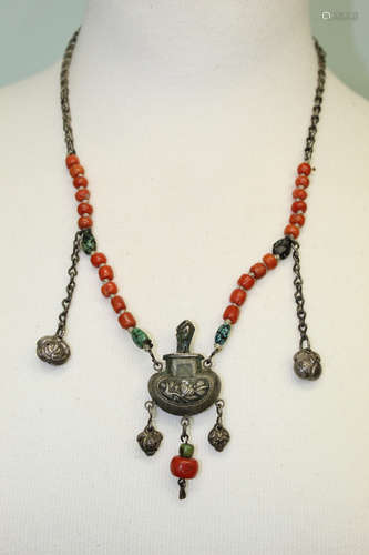 Chinese red coral necklace with silver pendant.