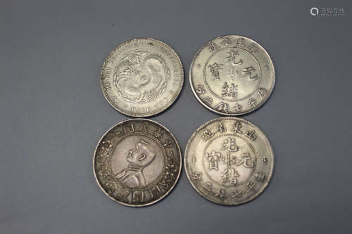 Four Chinese silver coins.