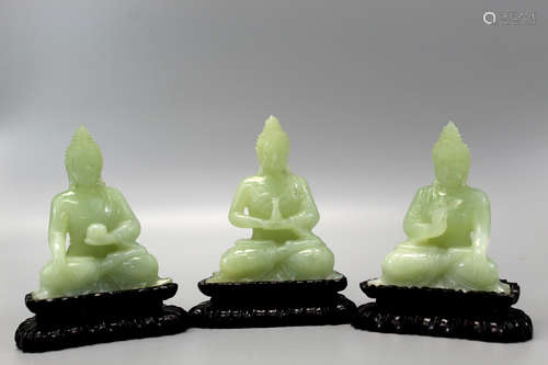 Three Chinese carved jade figures of Buddha on wood