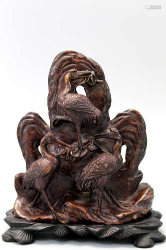 Chinese carved soapstone on wood stand.