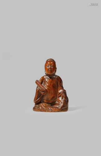 A SMALL CHINESE BOXWOOD CARVING OF A SCHOLAR