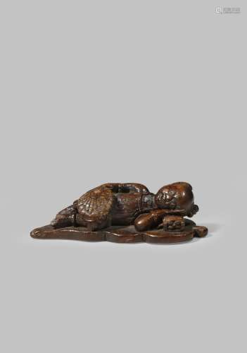 A CHINESE ALOESWOOD CARVING OF A SLEEPING BOY