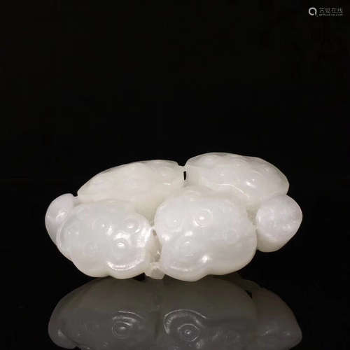 A HETIAN JADE CARVED LOTUS SEEDPOD SHAPED ORNAMENT