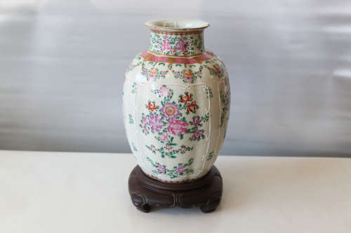 A chinese famille rose vase with hardwood base