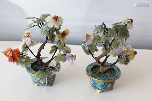 A chinese cloisonne pot with jade flower