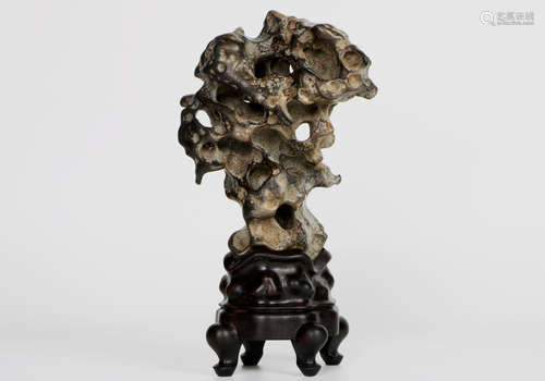 A chinese stone decoration with hardwood base