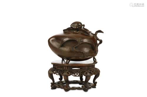 A CHINESE BRONZE 'PEACH' INCENSE BURNER AND COVER. Qing Dynasty. Cast in the form of a hollow peach
