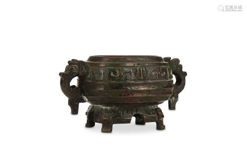 A CHINESE MINIATURE BRONZE GUI. Ming Dynasty. Standing on four paw feet issuing from animal masks