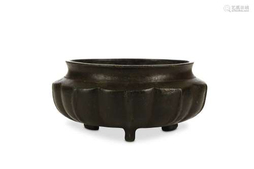 A CHINESE BRONZE INCENSE BURNER. Ming Dynasty. The body modelled with vertical stylised lappets