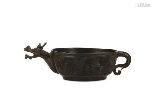 A CHINESE BRONZE POURING VESSEL WITH DRAGON HEAD SPOUT. 16th – 18th Century. The low circular basin