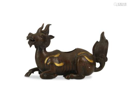A CHINESE PARCEL-GILT BRONZE ‘QILIN’ INCENSE BURNER. Ming Dynasty. Seated with the front right foot