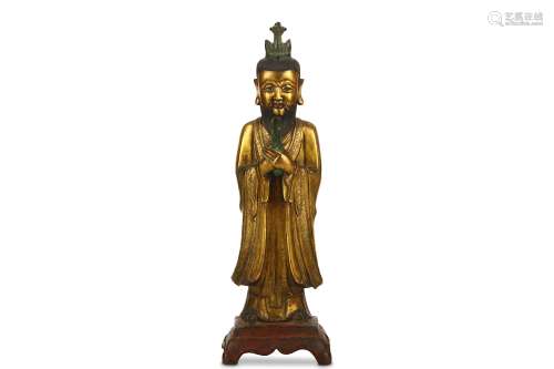 A CHINESE GILT BRONZE FIGURE. Ming Dynasty. Standing on a square base in long flowing robes, the